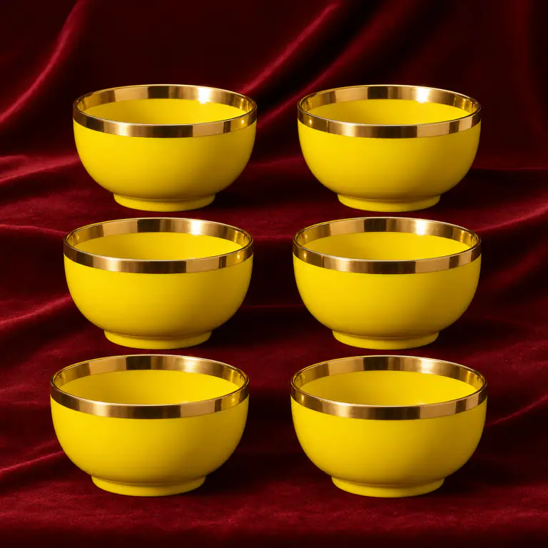 Yellow Glazed Tea Bowls shown on a red studio background