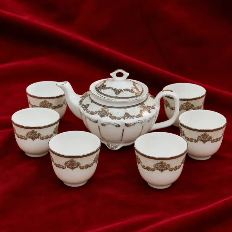 Ornamental White Tea Set shown on a red studio background