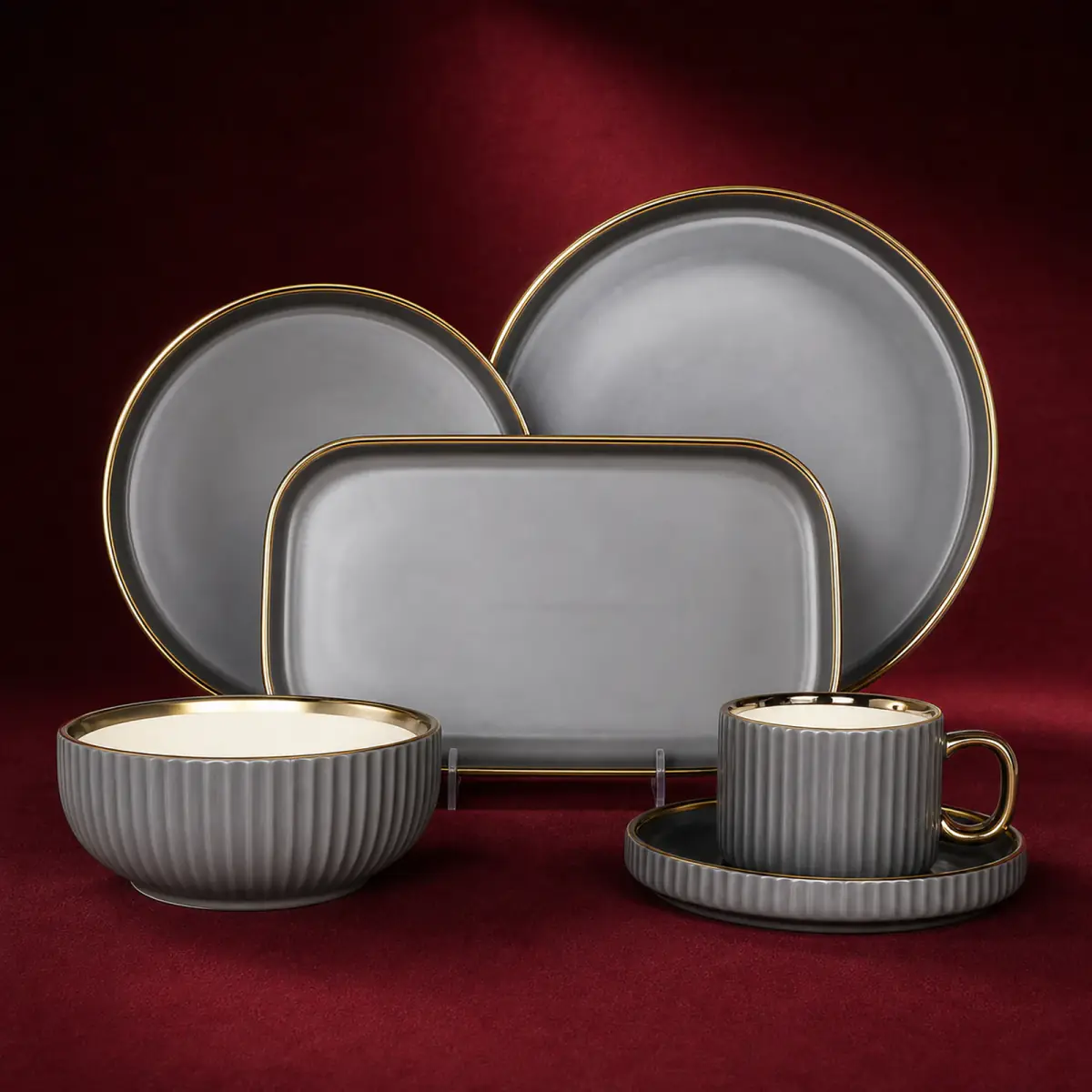 Grey Ribbed Tableware Set shown on a red studio background