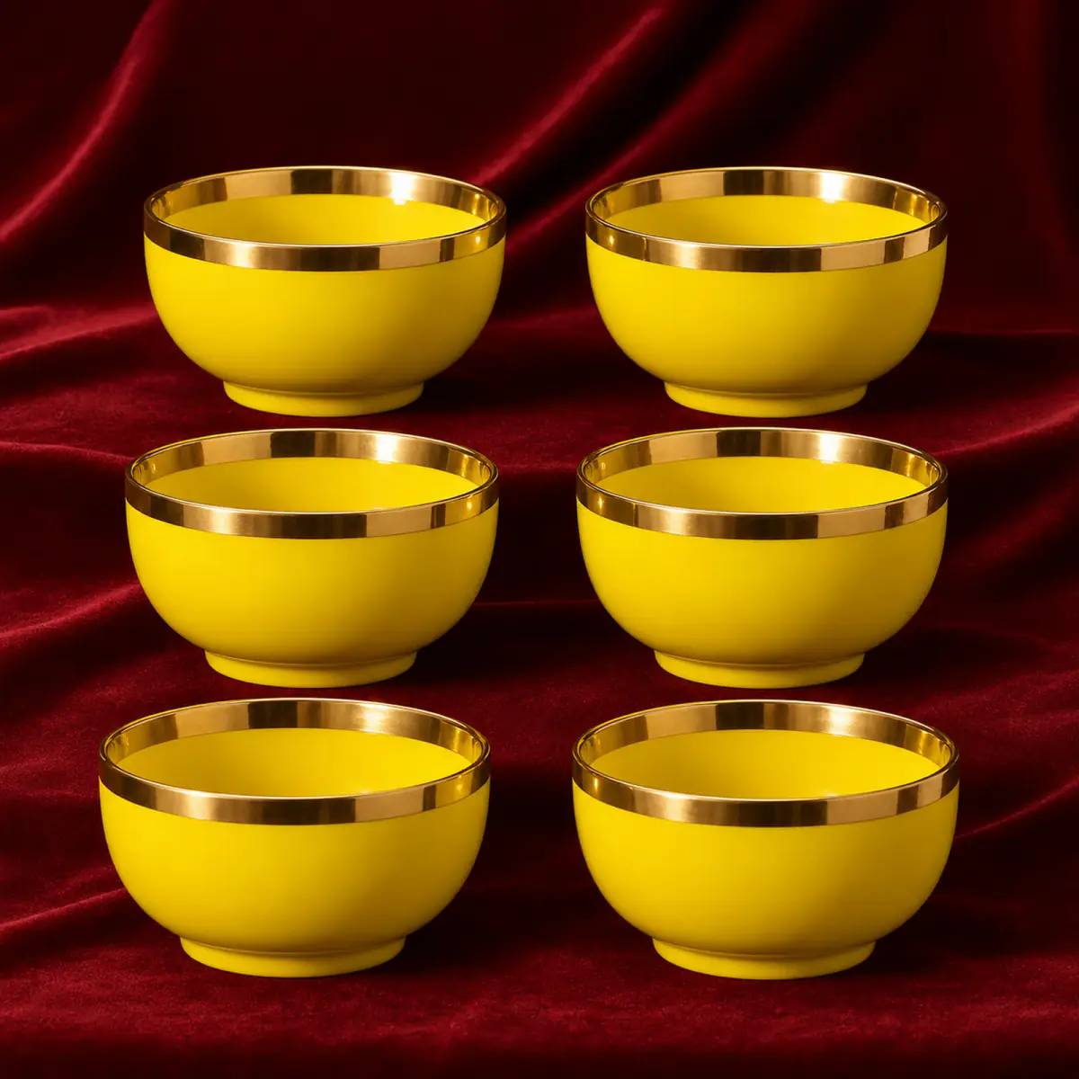Yellow Glazed Tea Bowls shown on a red studio background