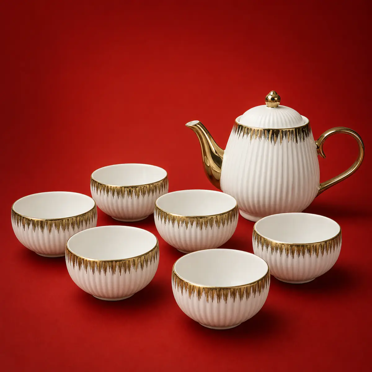 Brushed Gold Tea Set shown on a red studio background