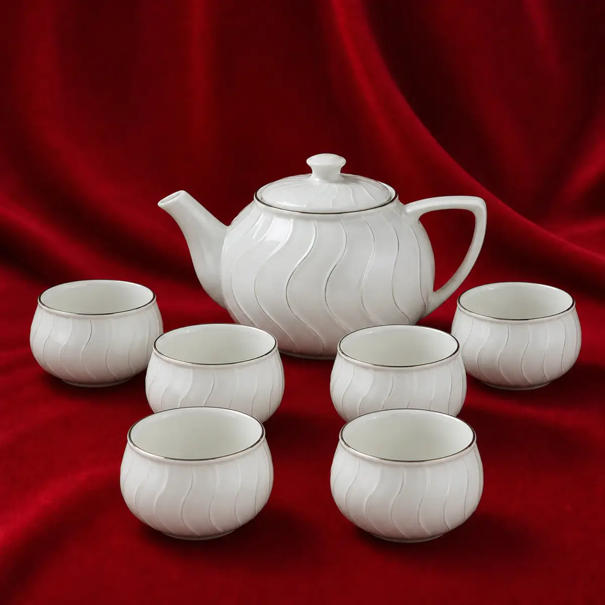Wave Relief Tea Set shown on a red studio background