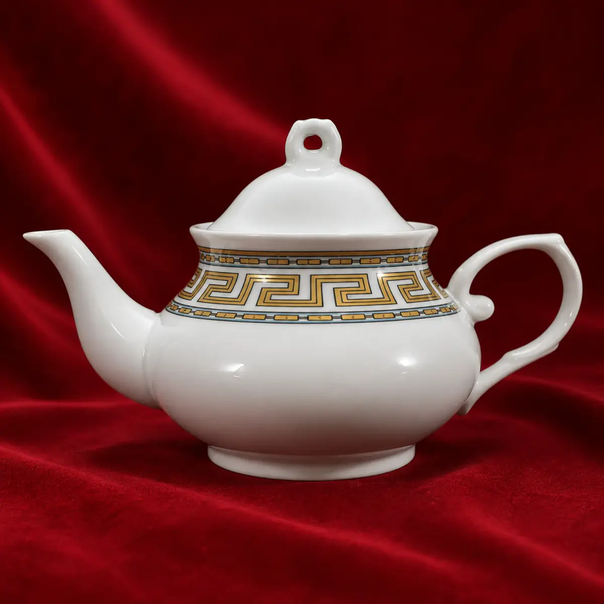 Ornamental Ink Decal Teapot shown on a red studio background