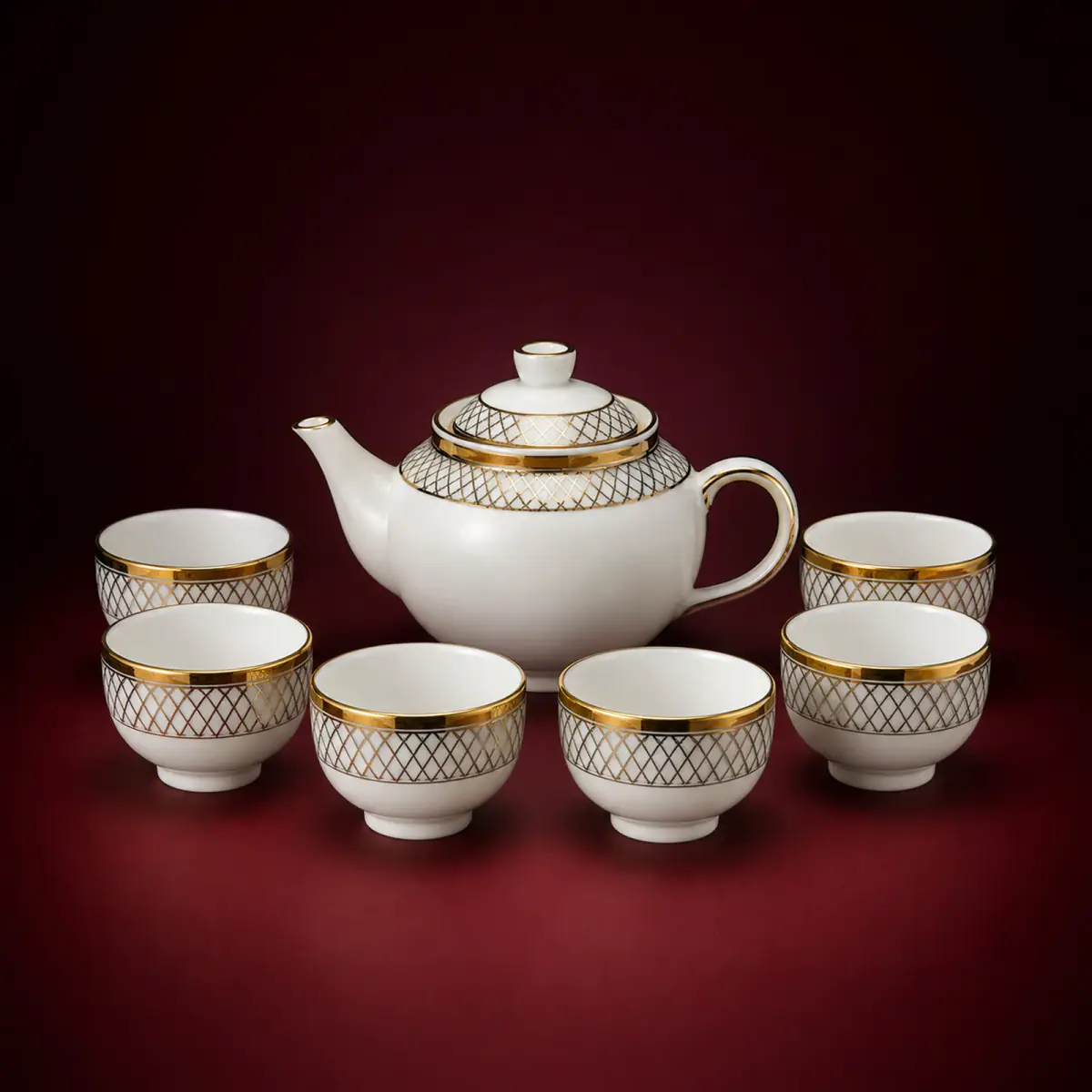 Gold Decal Tea Set shown on a red studio background